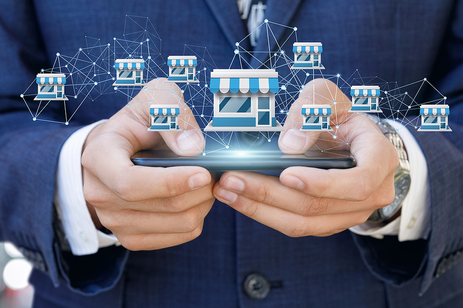 Businessman Showing Franchise System On A Mobile Device.